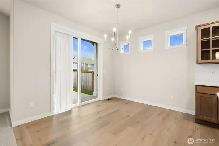 Dining nook with slider door to backyard.