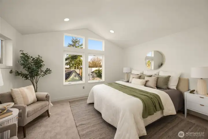 A tranquil primary suite featuring expansive windows and a neutral palette for the ultimate restful retreat