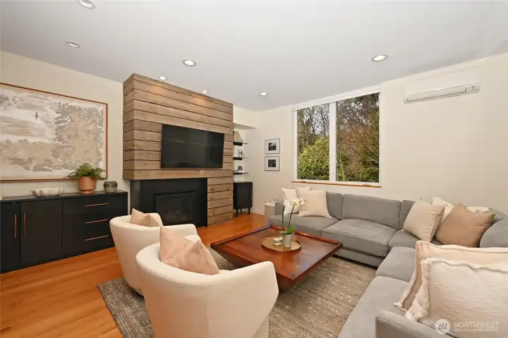 Exceptional details like white oak flooring and the interest of rough hewn boards accenting the fireplace