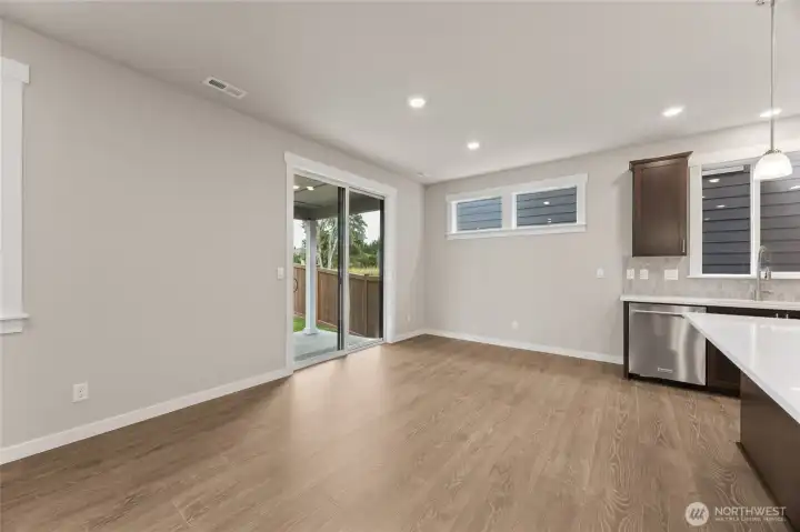 Dining area off kitchen island can accommodate large dining table.  Great photo showcasing large open concept great room. Actual home is under construction and materials, colors, and finishes will vary. See site agent for details.