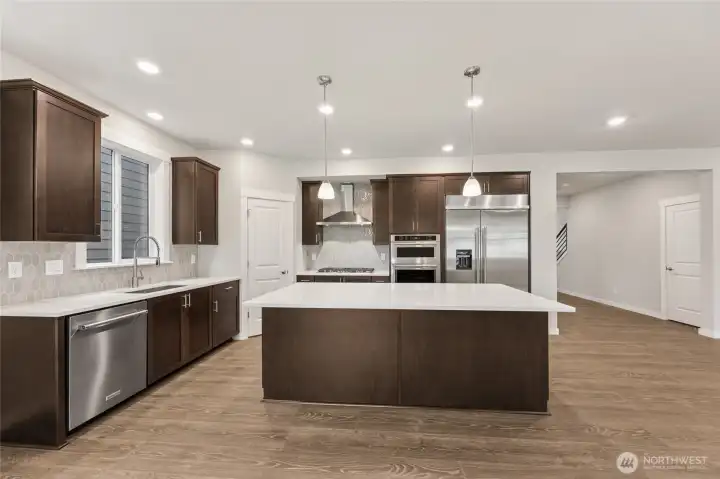 Huge center island to accommodate 4 bar stools.  Photos are representational. Actual colors and finishes will vary. See site agent for details.