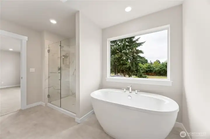 Large walk-in shower and soaking tub. Photos are representational. Actual colors and finishes will vary. See site agent for details.