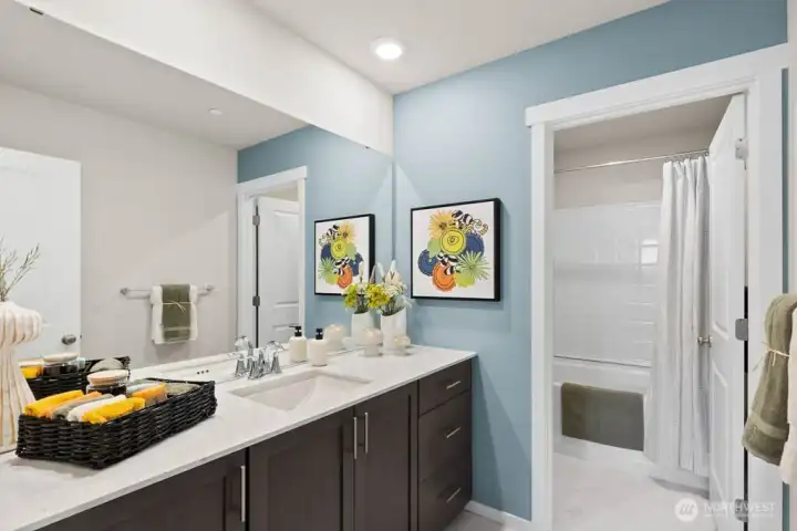 Hallway full bath with double vanity sink.  Photos are representational. Actual colors and finishes will vary. See site agent for details.