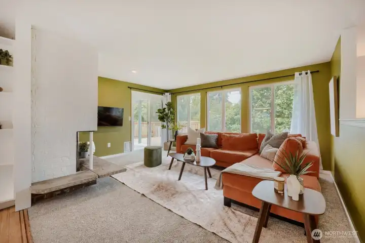 Living room with wood-burning fireplace and slider to the deck!