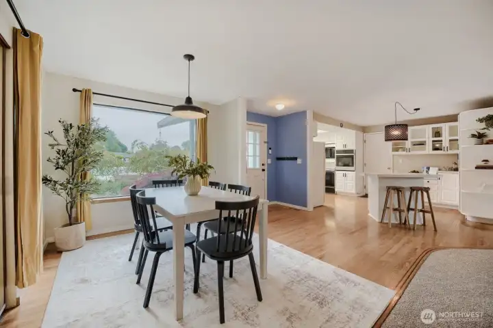 Dining room overlooks the front garden. Note the planning desk, additional cabinetry and large pantry space to the right of the kitchen island!