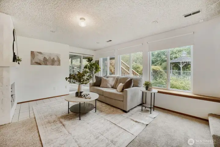 Second living room with another woodburning fireplace & slider to the covered patio.