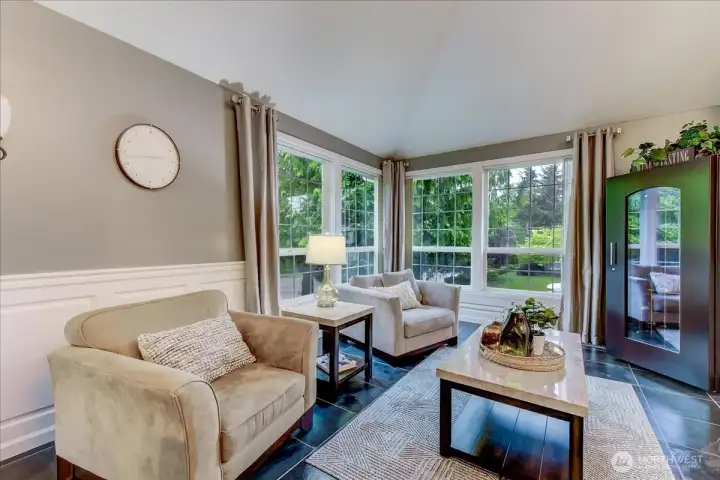 Spacious living room featuring exquisite custom woodwork, a signature design element found throughout the home.