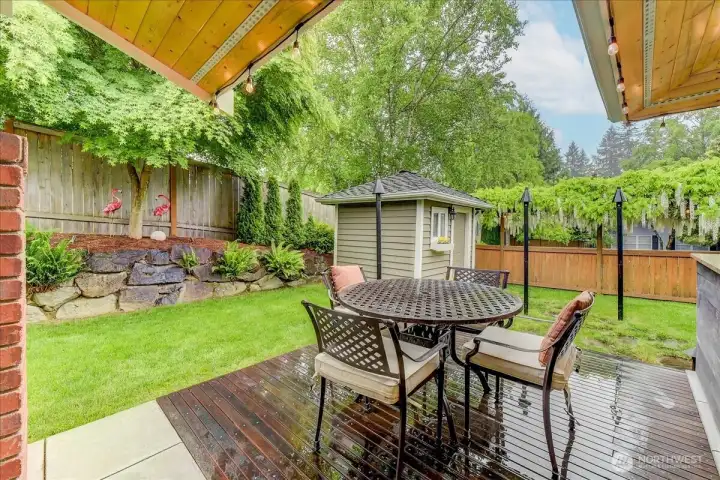 Spacious dining and entertaining area adjacent to the covered patio, featuring views of the meticulously groomed landscaping.