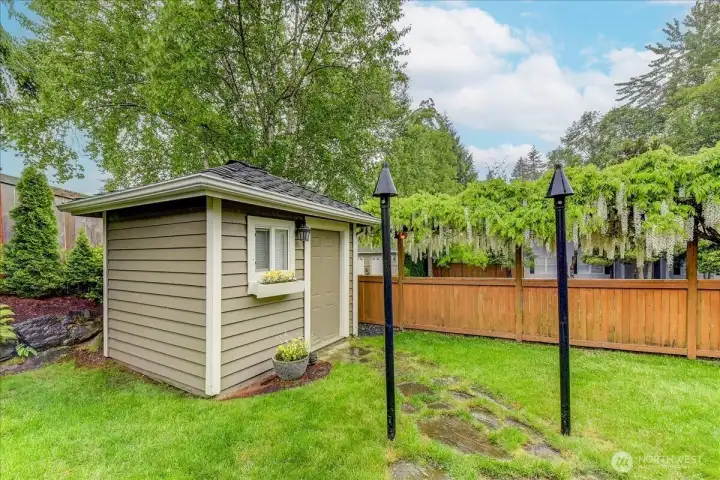 Professional 10' x 10' outbuilding featuring installed electricity, power outlets, and overhead lighting.