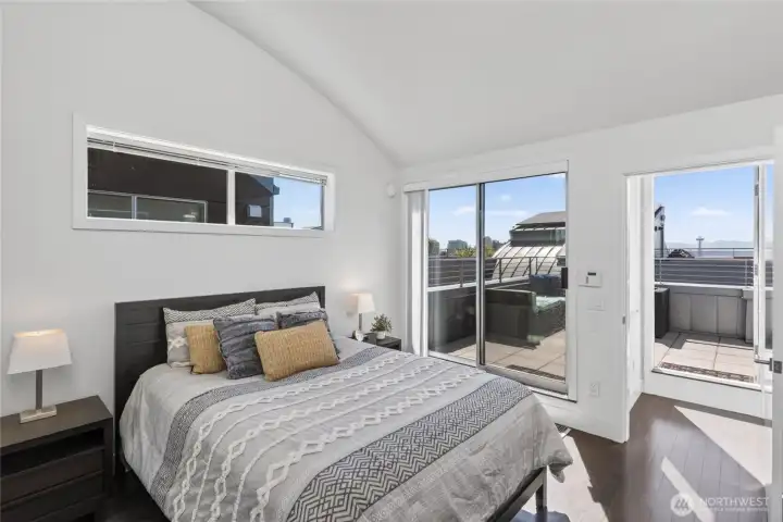 Primary bedroom with access to rooftop patio and views of Space Needle
