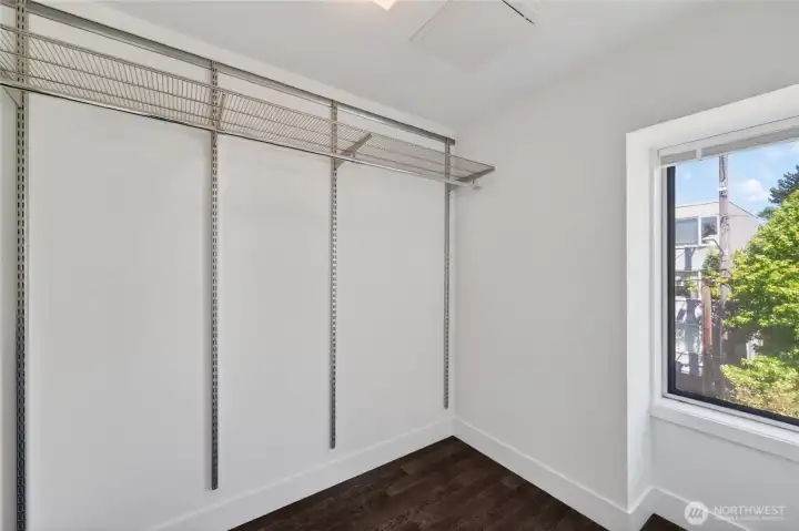 Large, well-lit, walk-in primary closet
