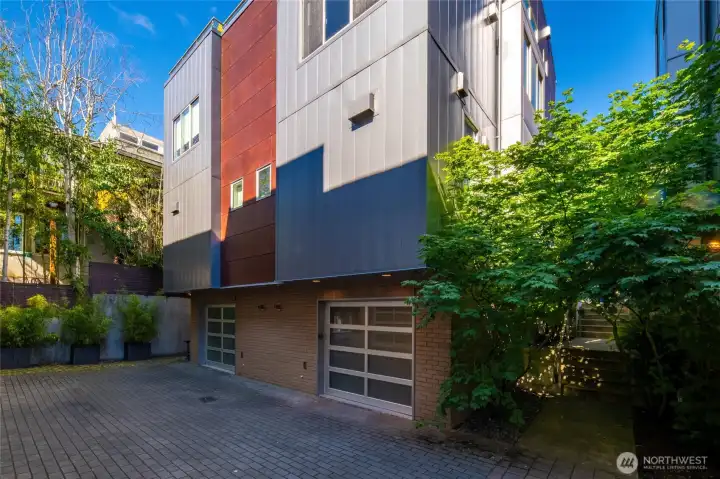 Back of condo with garage entrance