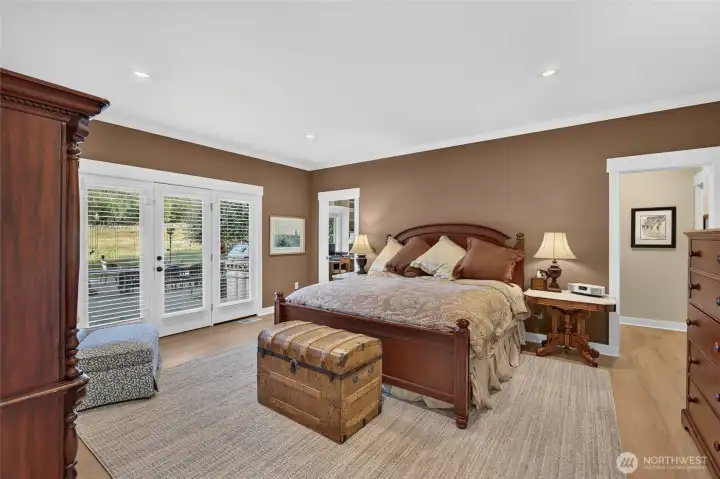 Generous primary bedroom with a door out to the patio,