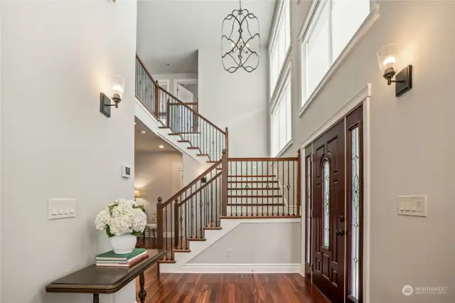 Another view of the elegant staircase with soaring ceilings.
