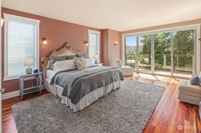 Private primary suite features a large deck, and southern facing windows. The morning light floods the home, and one can watch the sunset out on the deck to capture the brilliant colors!