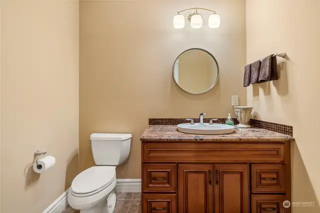 Lower level half bath. Easy access off of the garage and TV room.