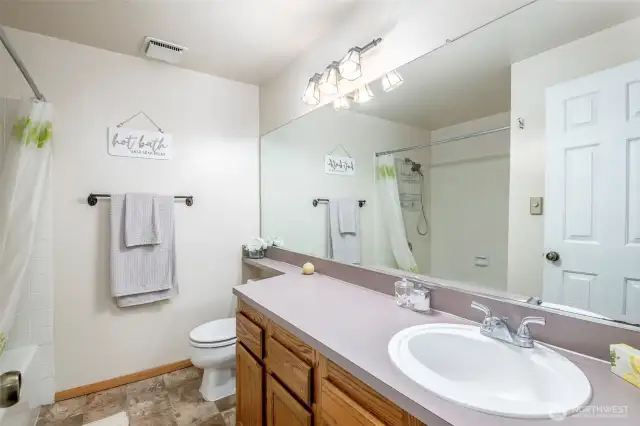 Hallway bathroom features a soaking tub/shower combo