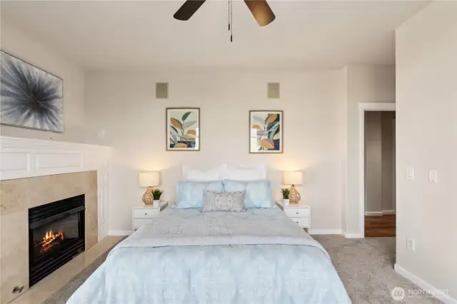 Primary Bedroom – Cozy Fireplace, Cool Ceiling Fan, and Instant Deck Access for Fresh-Air Luxury!