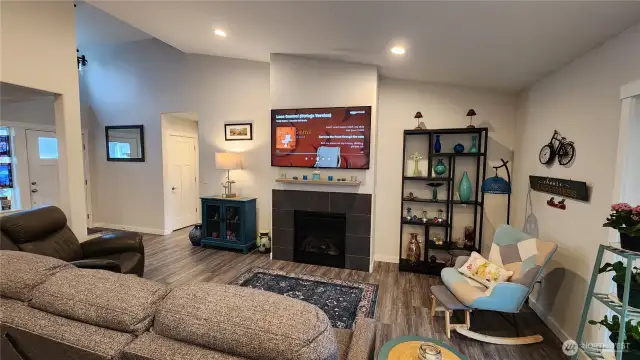 Living Room area with slider out to deck to your right, front door to your left and Primary suite is down the hallway to your right behind the wall on the East side of the house.
