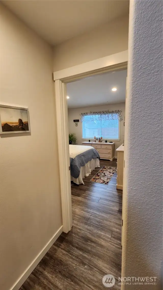 Hallway to primary bedroom with en-suite bathroom.
