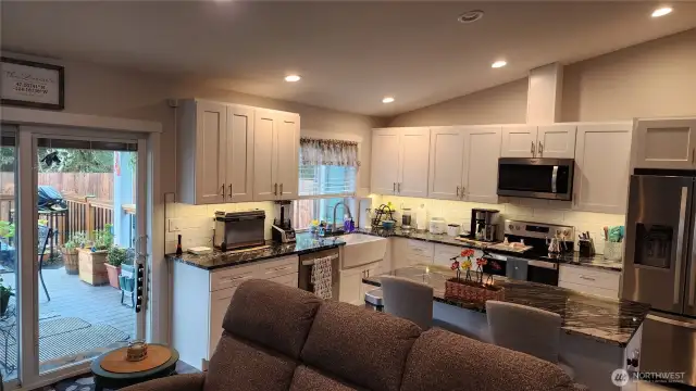 Kitchen has high-end countertops.  Extra seating at the island. Nice view from the Farmhouse sink overlooking the backyard. Lots of counter space and cabinets!