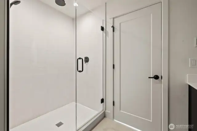 Spacious walk-in shower located in the primary bedroom.