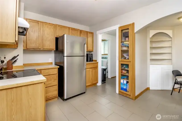 You’ll love how this kitchen keeps things organized—with bonus shelving, a built-in pantry, beautiful arch entry and an easy connection to the laundry area for everyday convenience.