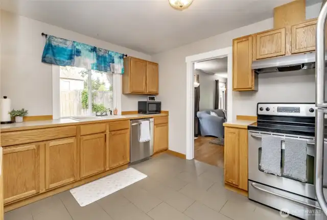 This bright window by the sink brings in natural light and offers a peaceful view to enjoy while cooking or cleaning up.  Lots of space to move around!