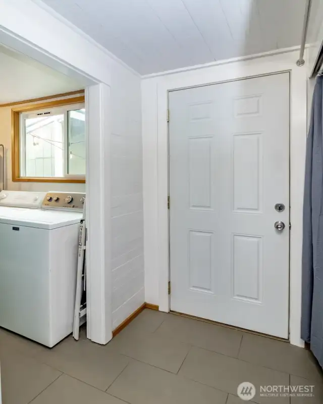 Just beyond the kitchen, you’ll find this utility area with tons of hidden storage and a door leading right to the backyard—perfect for storage, pantry and more!