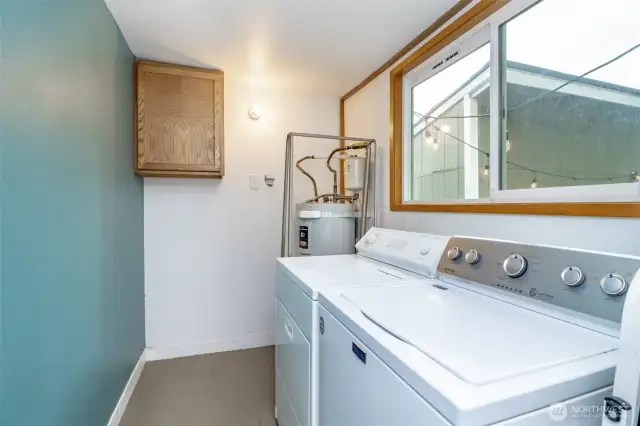 Do laundry with a view! Large windows let in natural light while giving you a peaceful peek at the backyard.