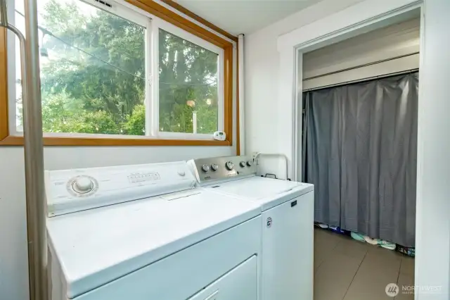This bright laundry room offers not just a place to do chores, but a cheerful space with extra storage and a pop of color. Tucked right off the kitchen for easy access!