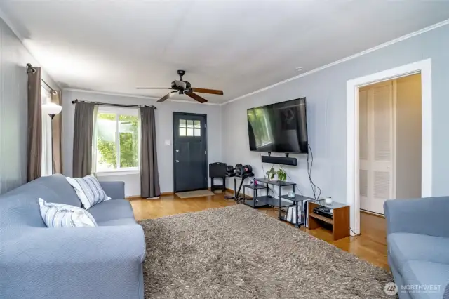 Light pours in from both sides, making this room feel bright, open, and inviting—perfect for relaxing after a long day or welcoming friends through the front door.