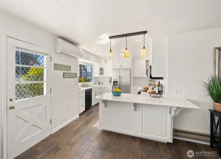 Gorgeous remodeled kitchen with plenty of counter tops and bar stool area, along with a beautiful view of the Hood Canal!