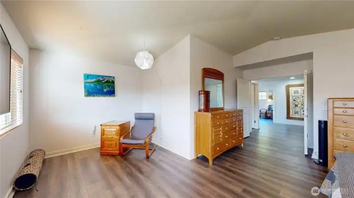 Expansive primary suite with sitting area and double-door entry.