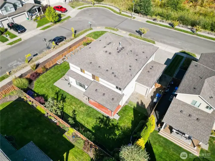 Aerial view of the spacious corner lot. Private setting with greenbelt views.