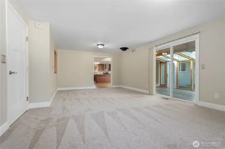 The main family room looking towards the Sunroom on the right, the kitchen straight ahead and the garage on the left.