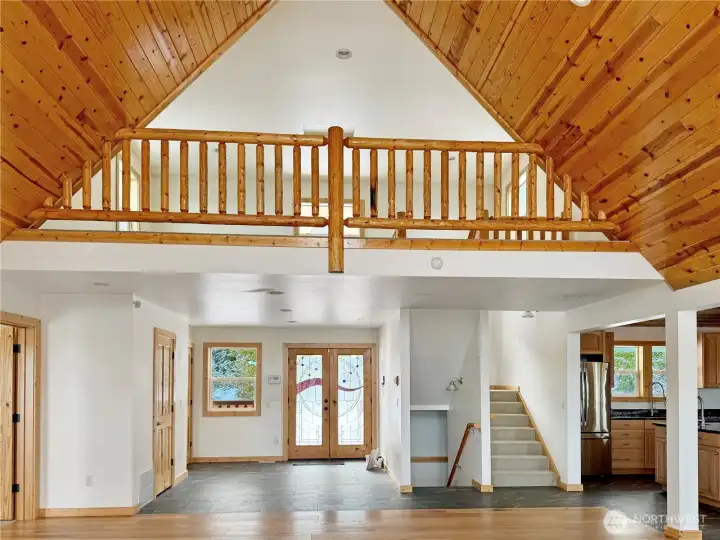 Toward the loft and front door, powder room not pictured, on left before coat closet.