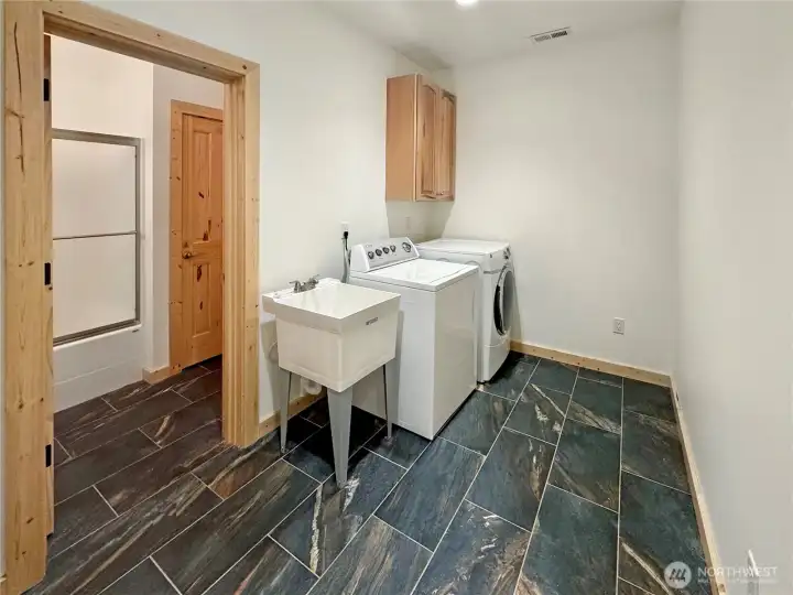 Laundry room, with utility sink and access to the full bath on the lower level.
