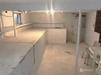 Large well-lit basement storage area.