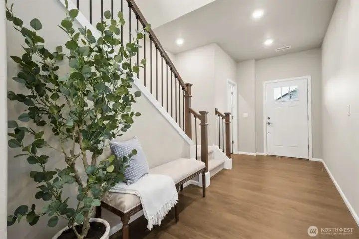 Durable luxury vinyl plank flooring extends throughout the entire main level, blending style and practicality. Its rich tone adds warmth to the open-concept spaces while offering easy maintenance and everyday resilience—perfect for both entertaining and busy living.