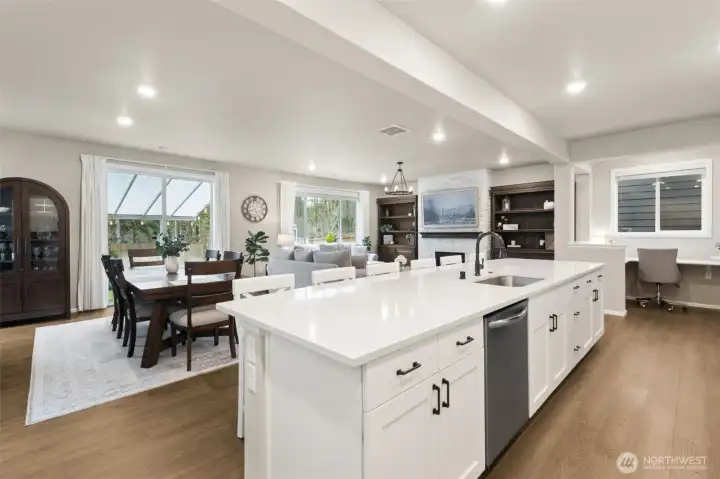 The dedicated dining area flows naturally from the kitchen, making dinner parties feel effortless. Large windows frame calming greenbelt views.