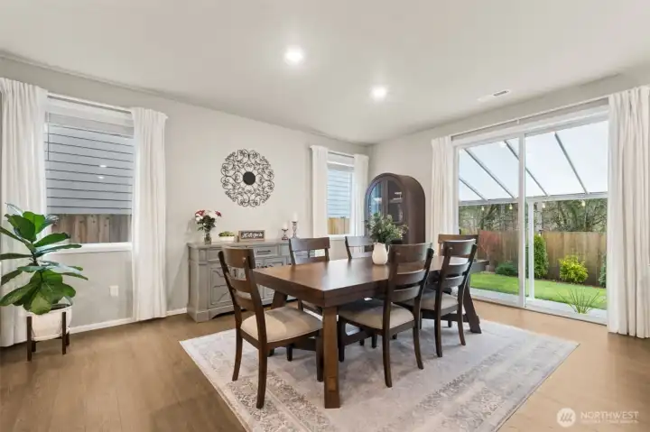 The spacious dining area is designed for both everyday meals and memorable get togethers, with plenty of room! Large windows and direct access open seamlessly to the covered back patio, where peaceful greenbelt views create a beautiful and private backdrop for indoor-outdoor living.