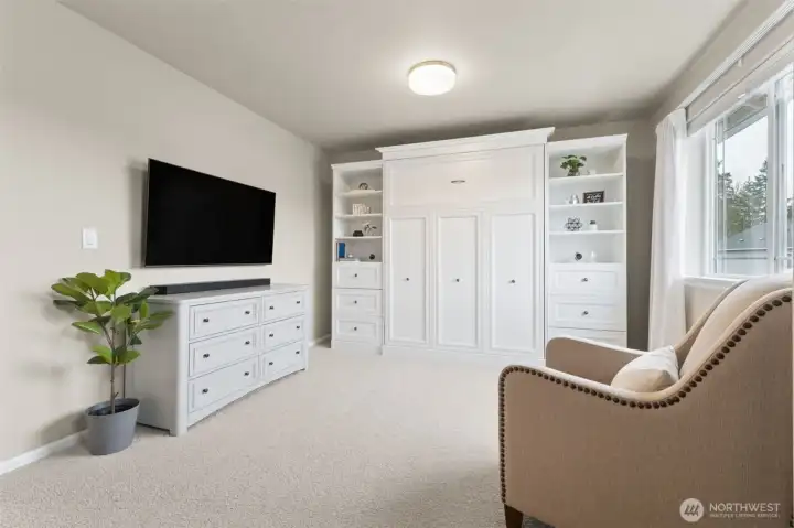 Bedroom #4 shown here with a Murphy bed. The walk-in closet is set up as a cozy home office/work station.