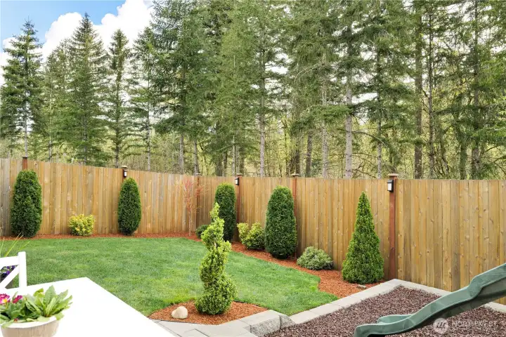 This backyard backs to a dedicated community greenbelt, offering exceptional privacy and a peaceful setting. Thoughtful landscape lighting enhances the space with a warm, inviting ambiance.