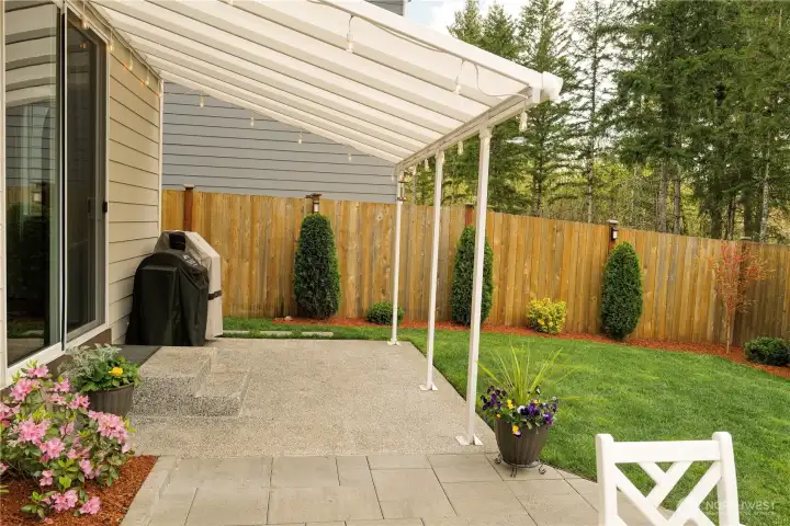 The spacious covered patio offers protection from PNW sprinkles or Summer sun. A perfect place to stash your grill!