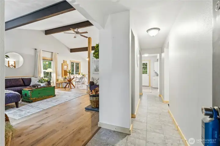 Entry hallway to living room and door to patio.