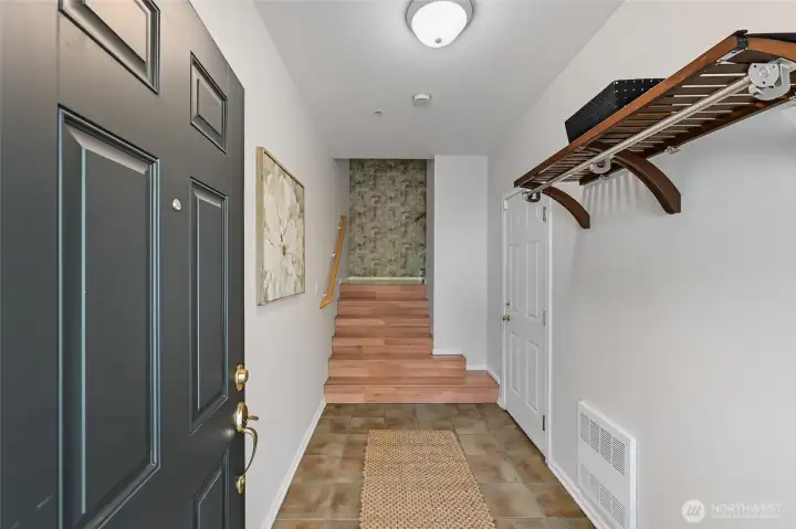 Step into a generously sized entryway that offers a warm and inviting first impression, with convenient access to the garage just to the right.