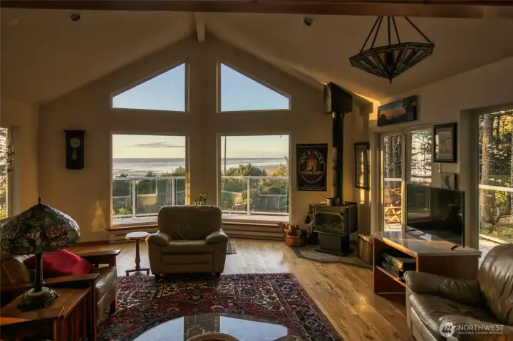 Once inside this lovely home you can relax and enjoy the open and beautiful space.  Wall of glass, vaulted beamed ceilings and a cozy wood burning stove to keep you warm especially if the wind takes the power out.