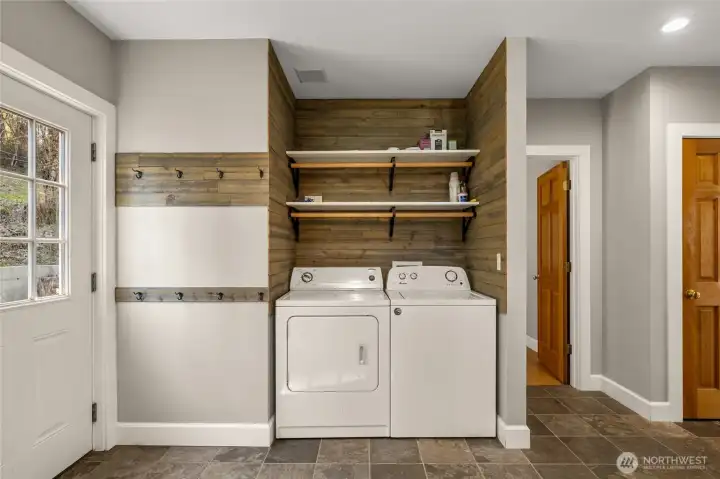 Main floor laundry area/mudroom.Washer & Dryer stay! Beautiful slate floors.