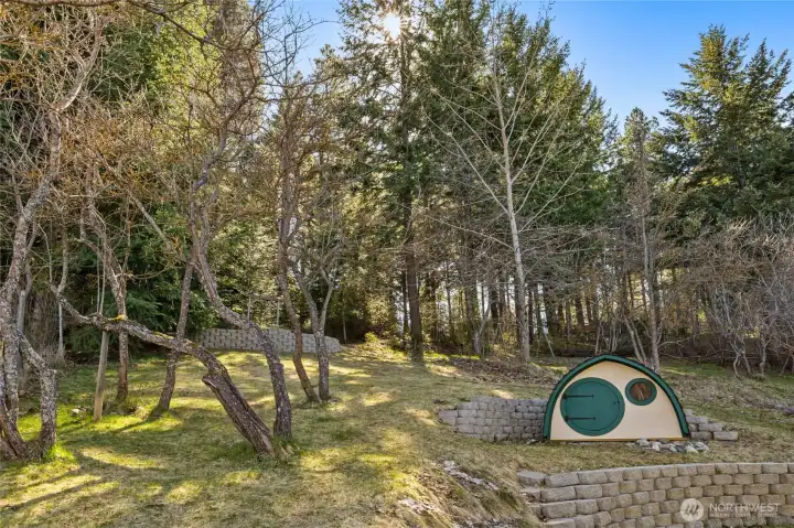 This is such a fun back yard! Spring brings plums trees, pear trees, & Italian plums! There is also a drip irrigation system for the garden beds.